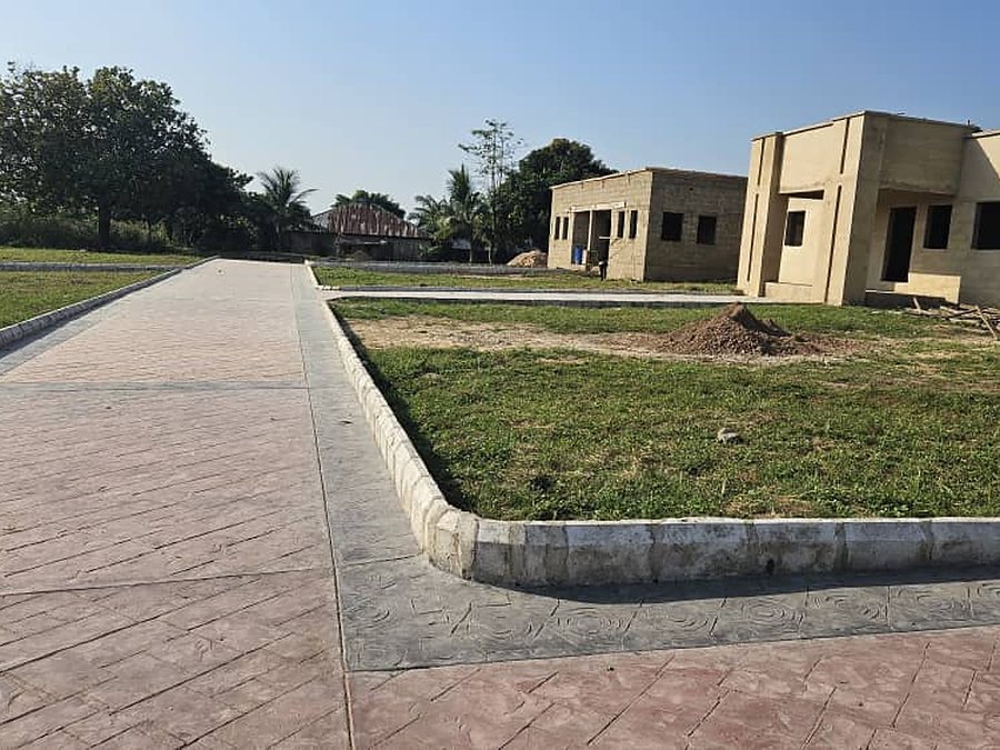 A new block going up at the John Stilley Schools, Victoria-Ikom, beside a paved walkway