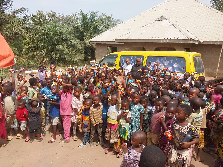Refugee children at a CORAfrica distribution, beside the school bus