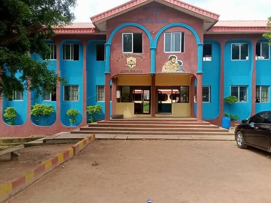 The front of St. Joseph&rsquo;s Schools, Idum-Mbube, a two-storey block in blue and red