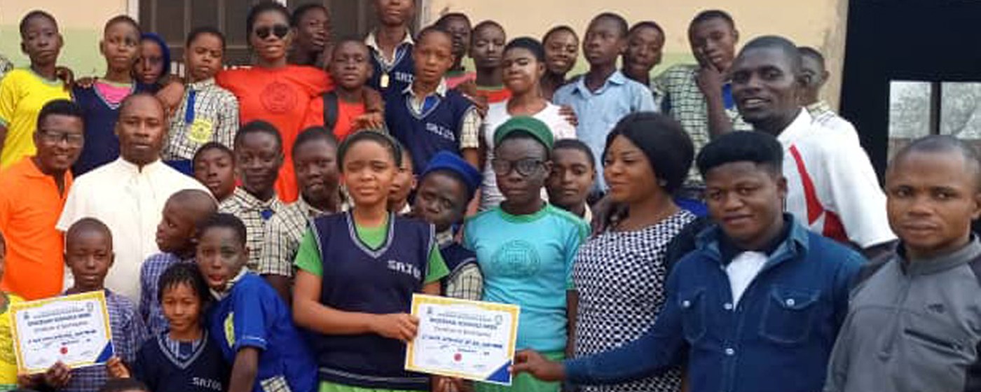 Students and staff with their certificates